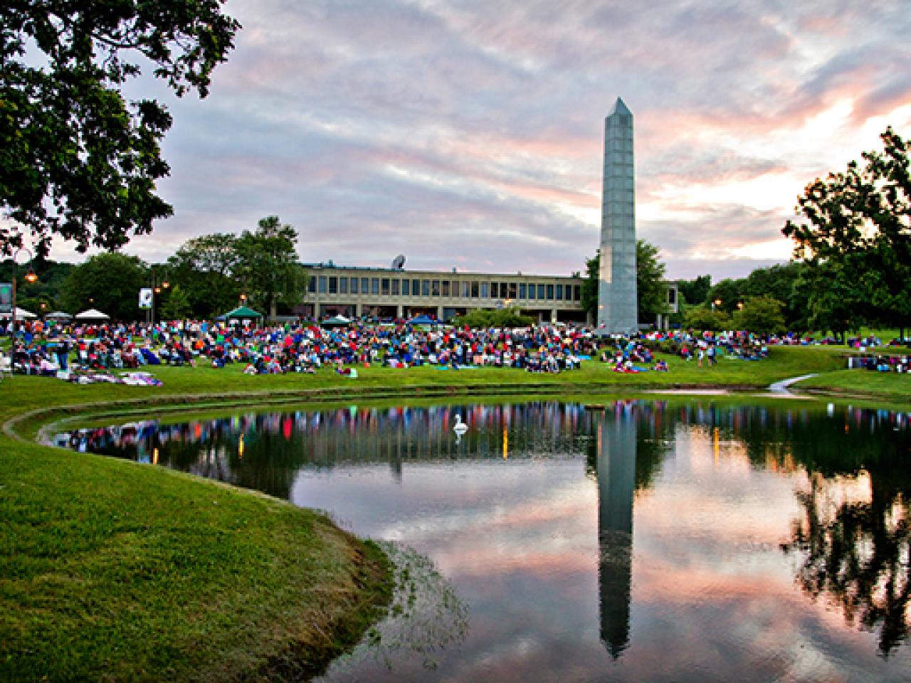 Crowd sitting at dusk at July 3rd Fireworks and Concert, Newark Campus