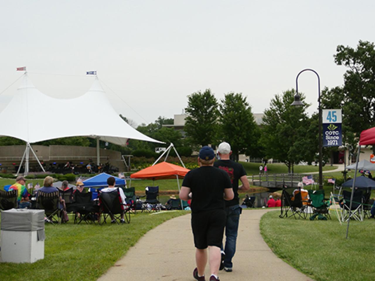 Two concert-goers walk along the path at Newark Campus July 3rd Fireworks and Concert