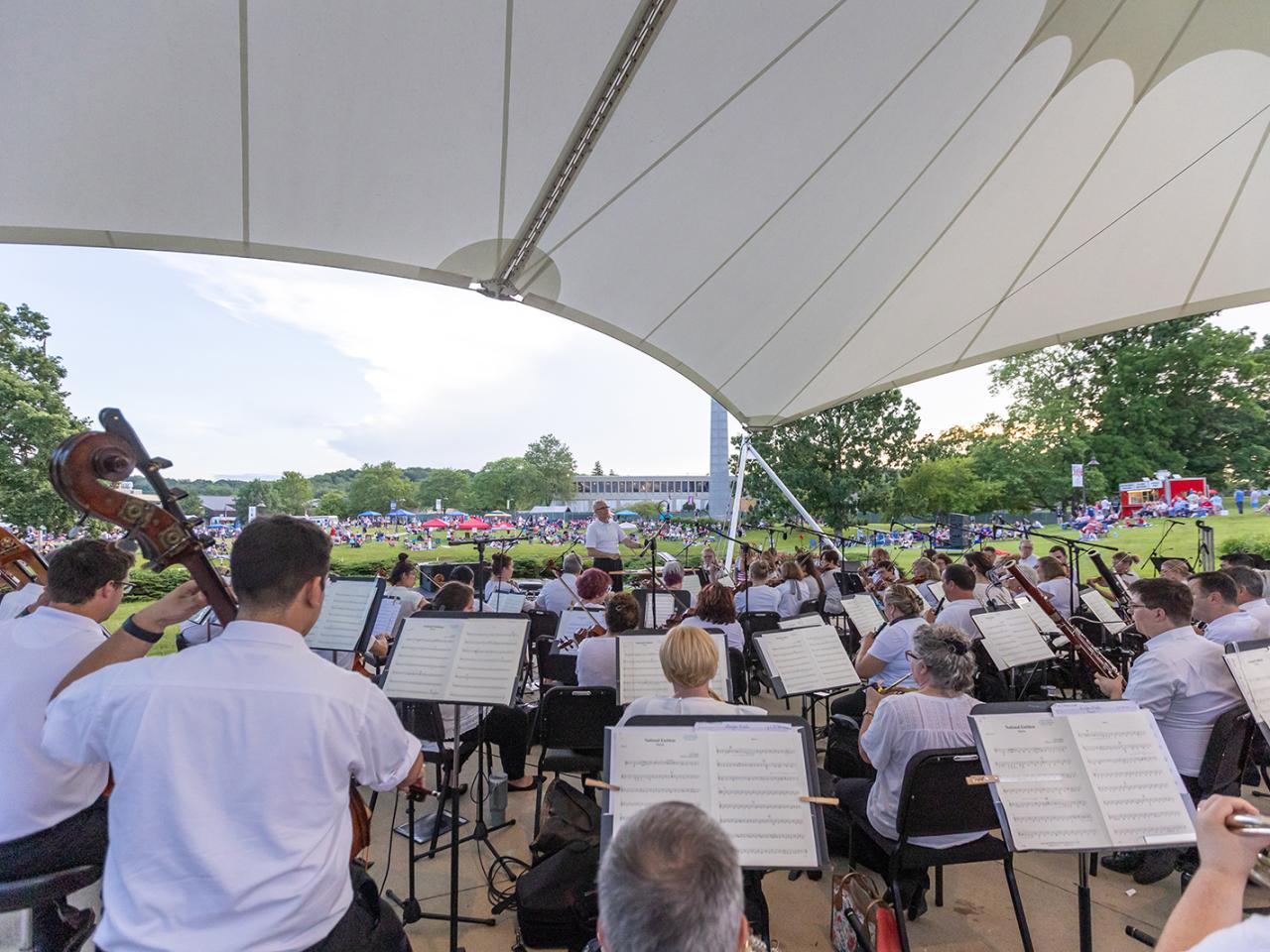 The Newark Granville Symphony Orchestra fills the Martha Grace Reese Amphitheatre playing live music for guests.
