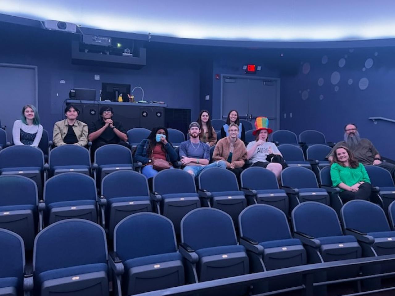 Students sit in the SciDome planetarium. 