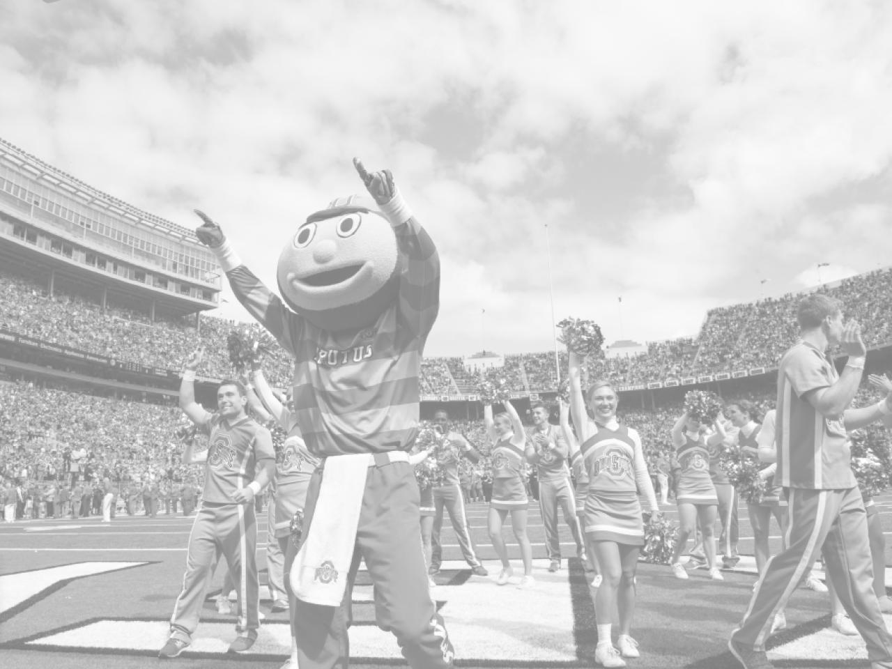 Brutus Buckeye leads a group of cheerleaders in Ohio Stadium.