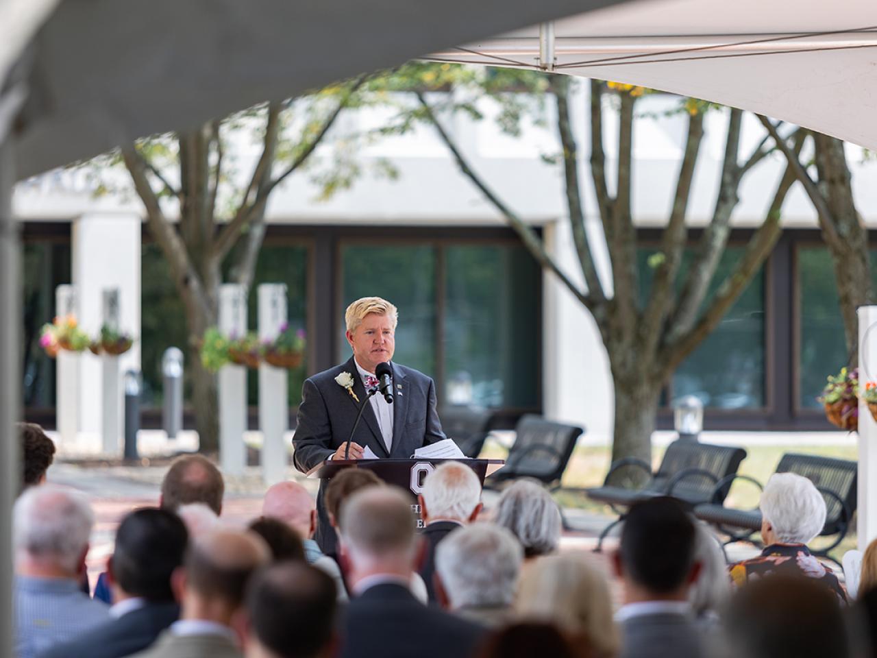 COTC President John Berry address attendees at a ribbon cutting ceremony for the newly renovated Hodges Hall.