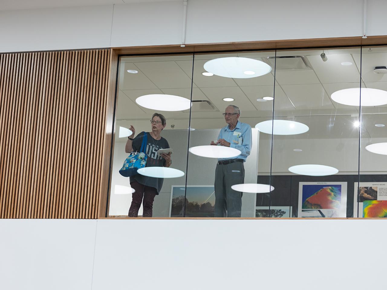 Guests gaze out of a third-story window in the newly renovated Hodges Hall.