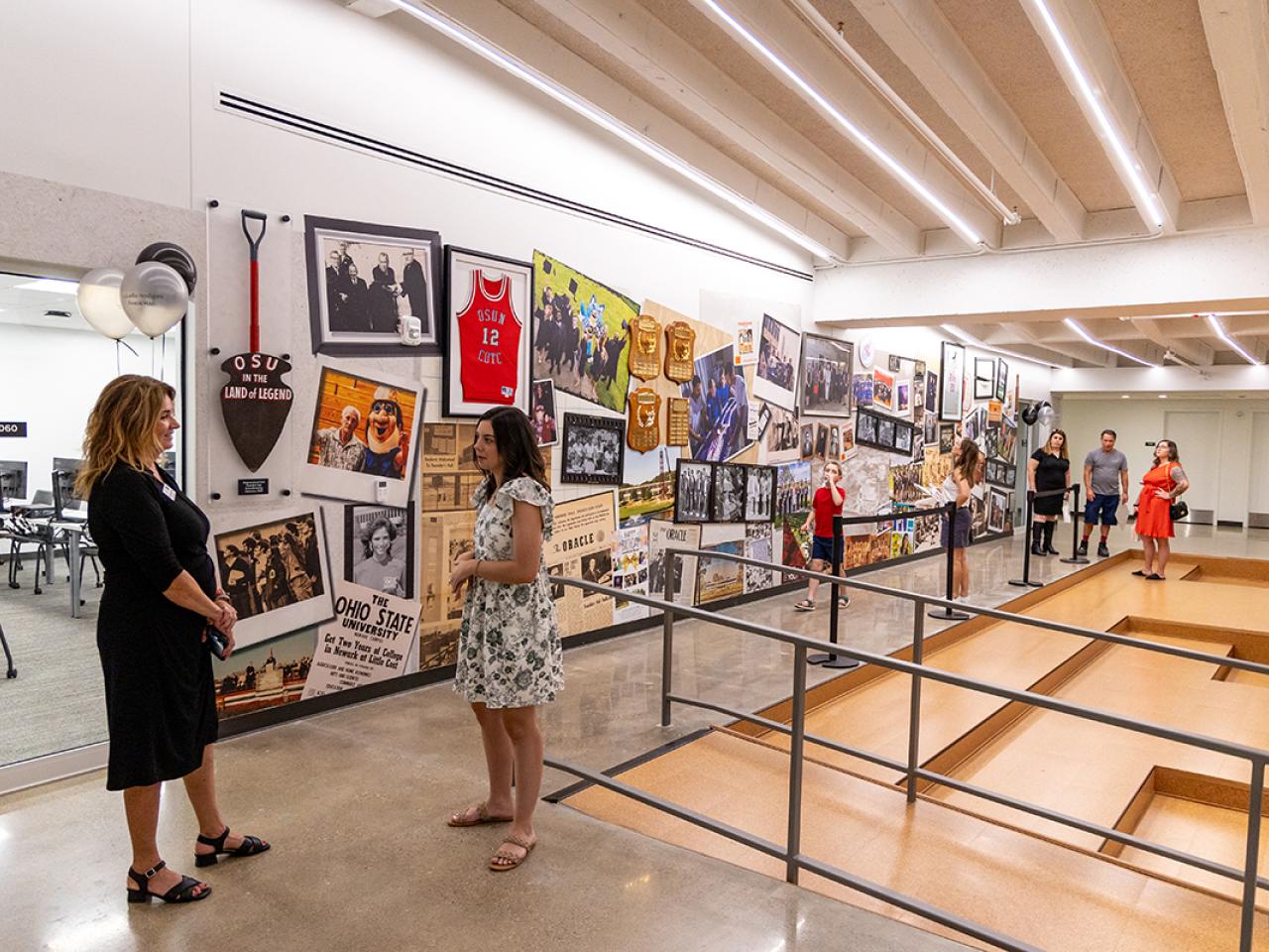 Guests converse in the bottom floor of the newly renovated Hodges Hall.