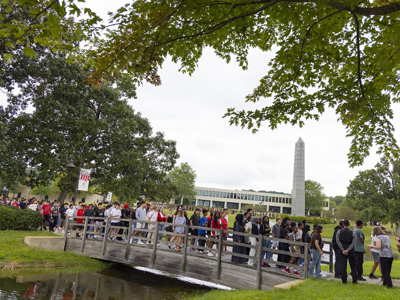 Freshman students walk across the bridge in the center of campus. 