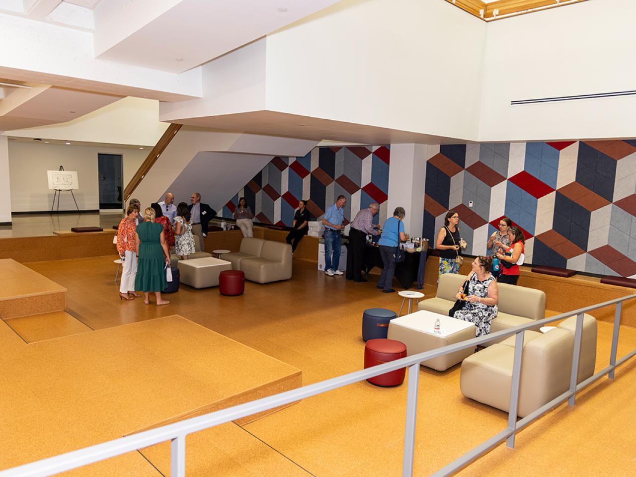 Guests gather on the lower level of the newly renovated Hodges Hall.