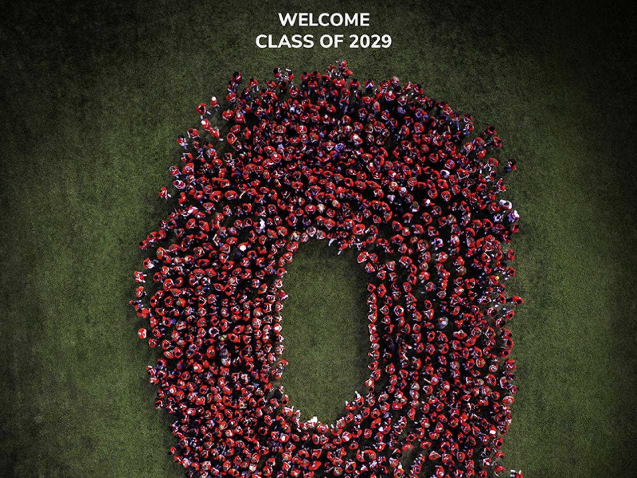 An aerial photo of students wearing red t-shirts in the formation of a Block O.