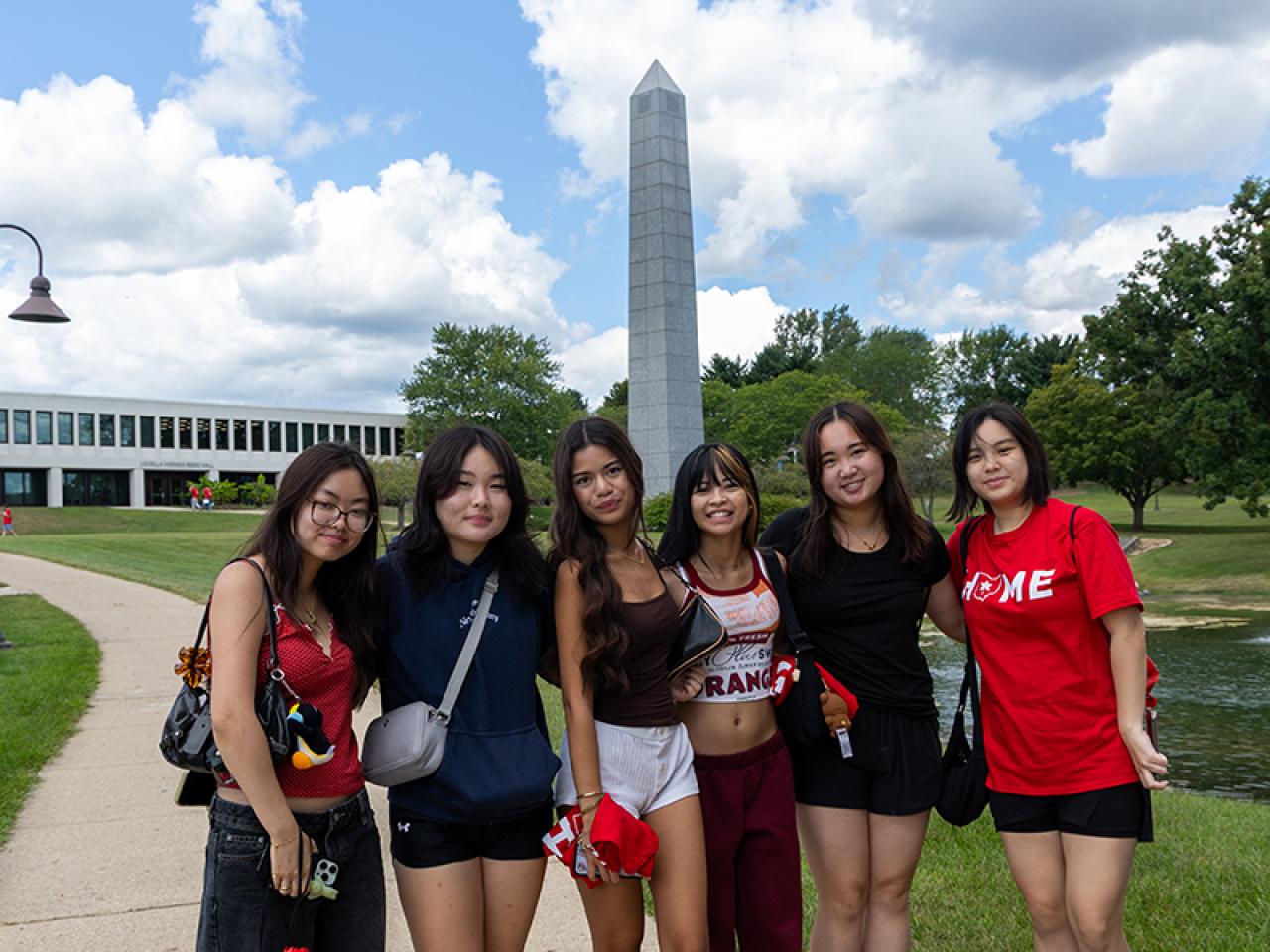 A group of six students pose on campus following Convocation.