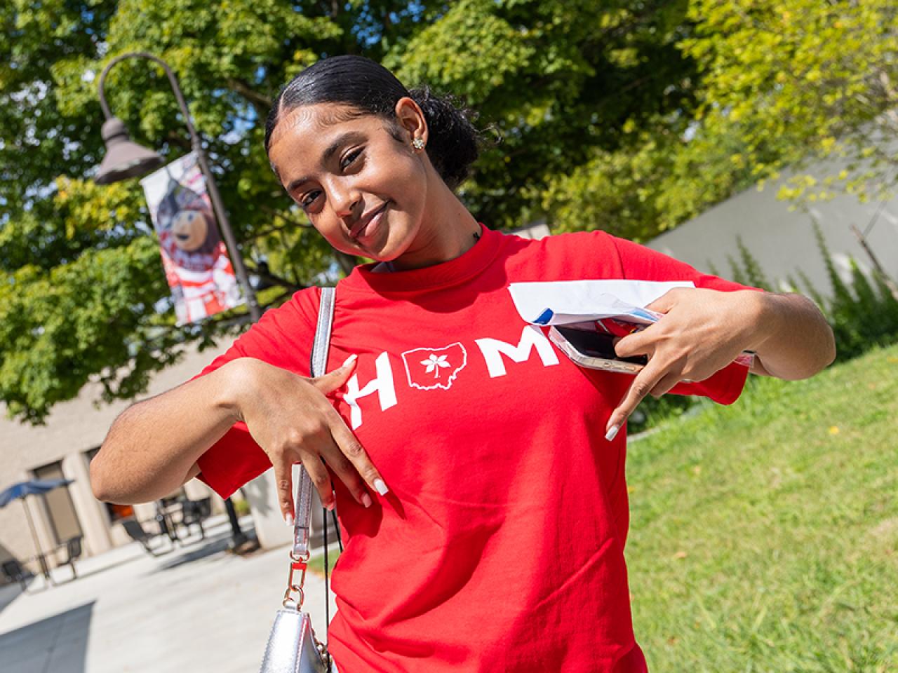 A student poses on campus following Convocation.