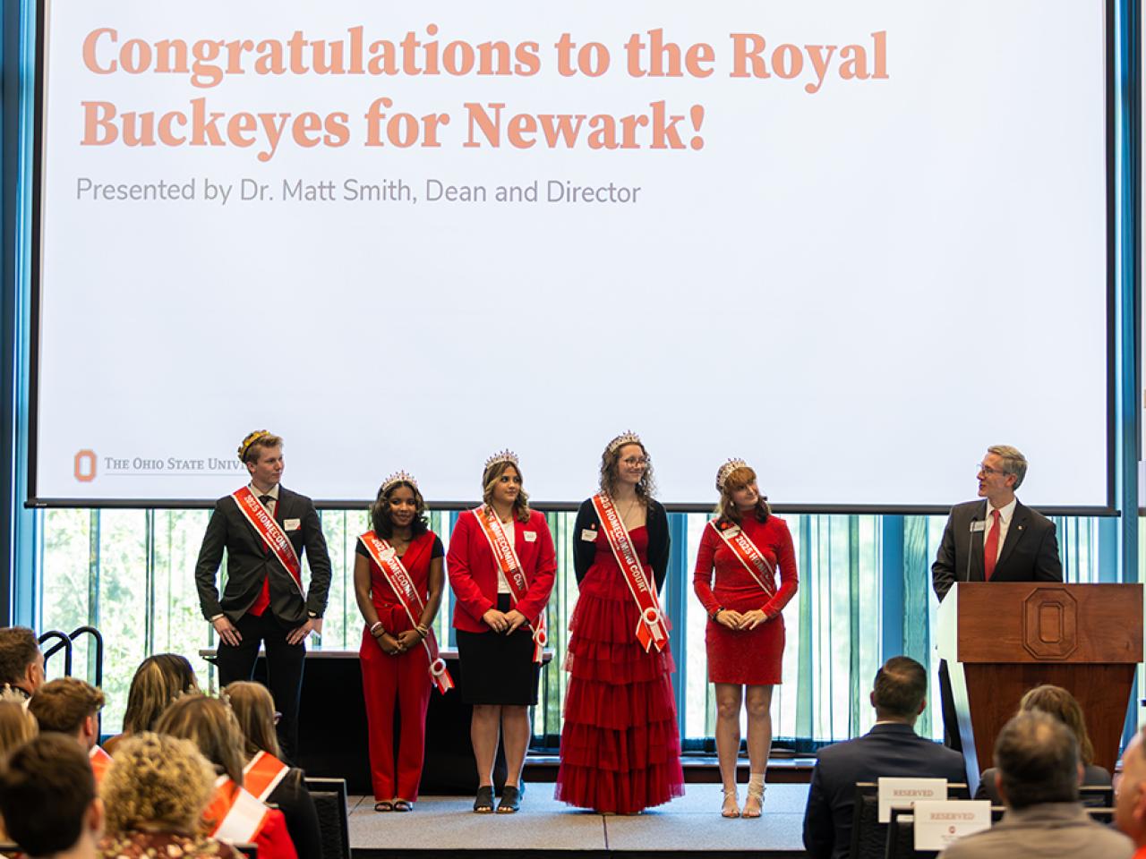 Ohio State Newark Homecoming Court members are introduced on stage by dean and director Matt Smith at the regional campus Homecoming recognition ceremony.