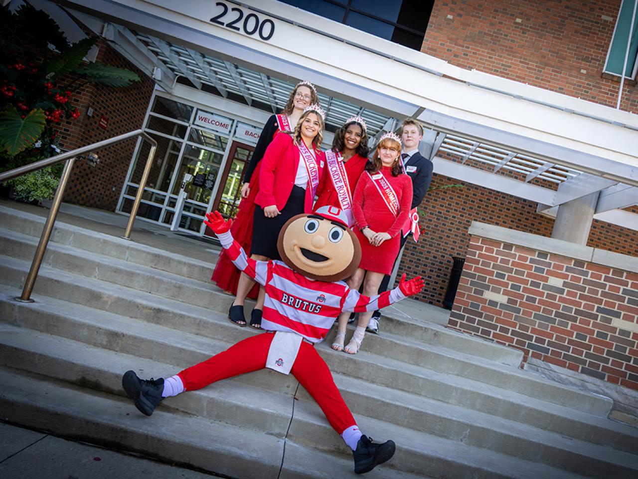 Ohio State Newark Homecoming Court members with Brutus Buckeye outside the Longaberger Alumni House for the regional campus Homecoming recognition ceremony.