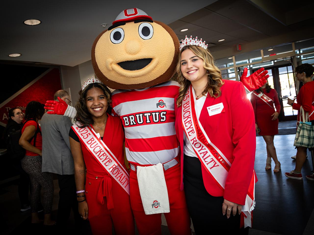 Ohio State Newark Homecoming Court members and Royal Buckeyes Nia Coats and Jaylyn Workman with Brutus Buckeye at the Longaberger Alumni House for the regional campus Homecoming recognition ceremony.