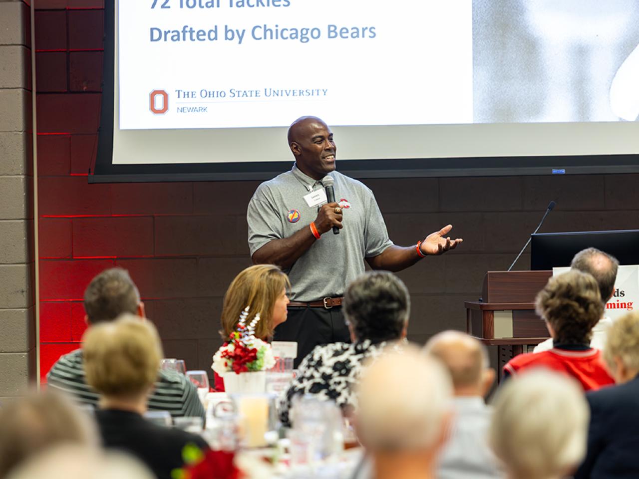 James Cotton addresses a crowd from the podium.