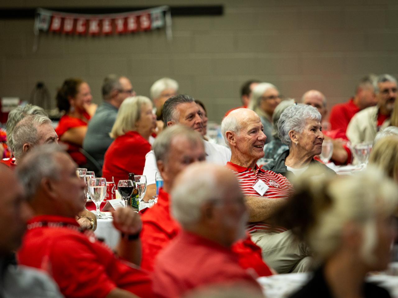 Guests seated at tables during the alumni Homecoming celebration in the Reese Center.