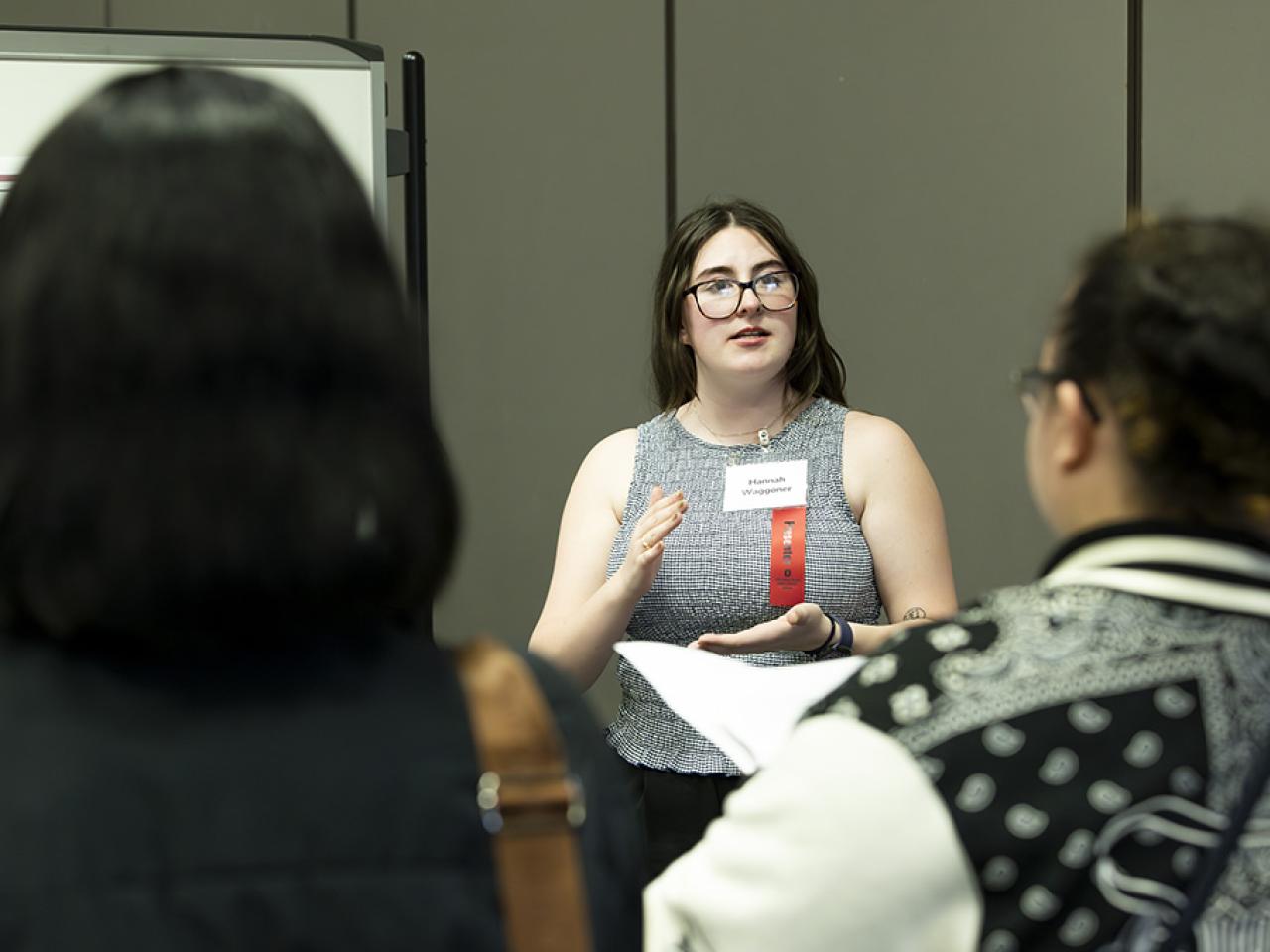 Hannah Waggoner looks at her audience as she presents her poster presentation at the Student Research and Creative Inquiry Forum.