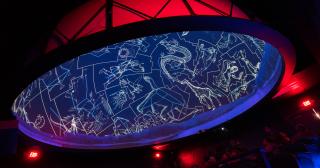 The dome of the SciDome planetarium is lit with constellations. 