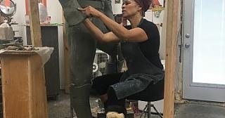 Dana King works on forming the sleeve of a life-size statue. 