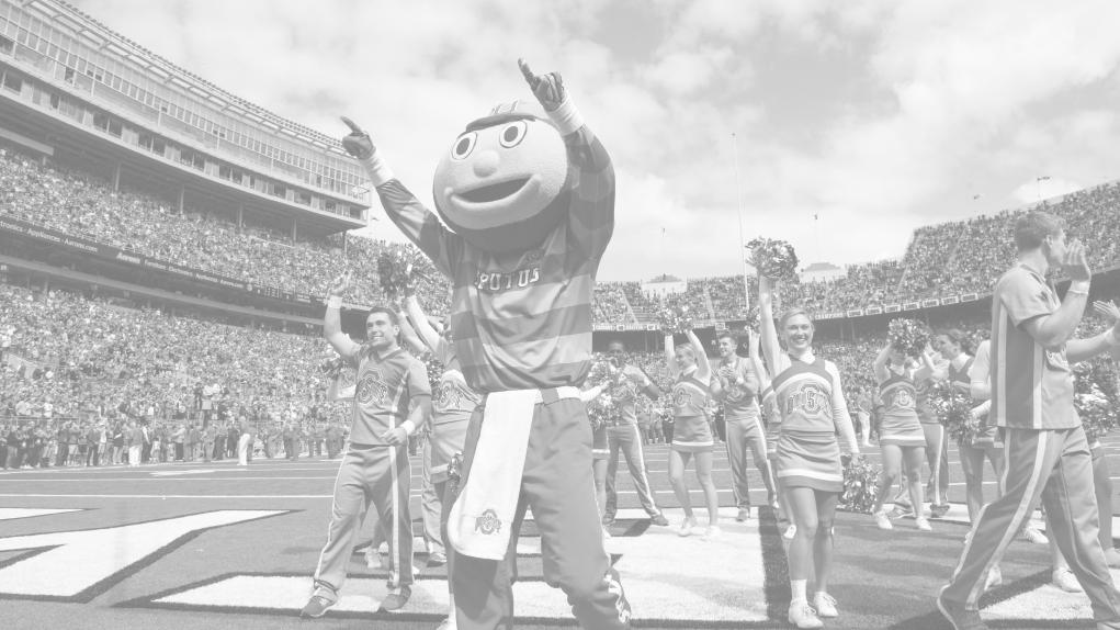 Brutus Buckeye leads a group of cheerleaders in Ohio Stadium.