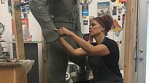 Dana King works on forming the sleeve of a life-size statue. 