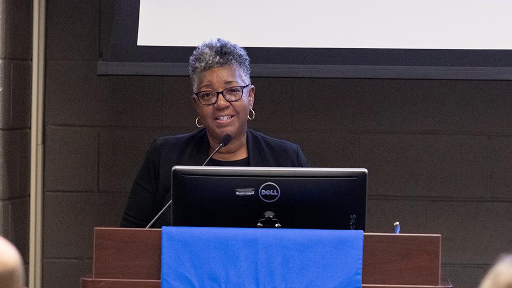 Vorley Taylor stands at a podium speaking at COTC's Legacy and Leadership Dinner in 2023.