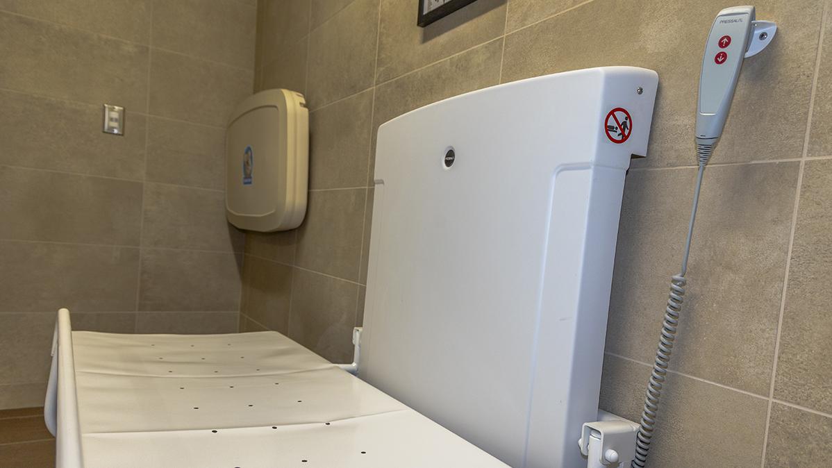A universal changing station is mounted on a wall.
