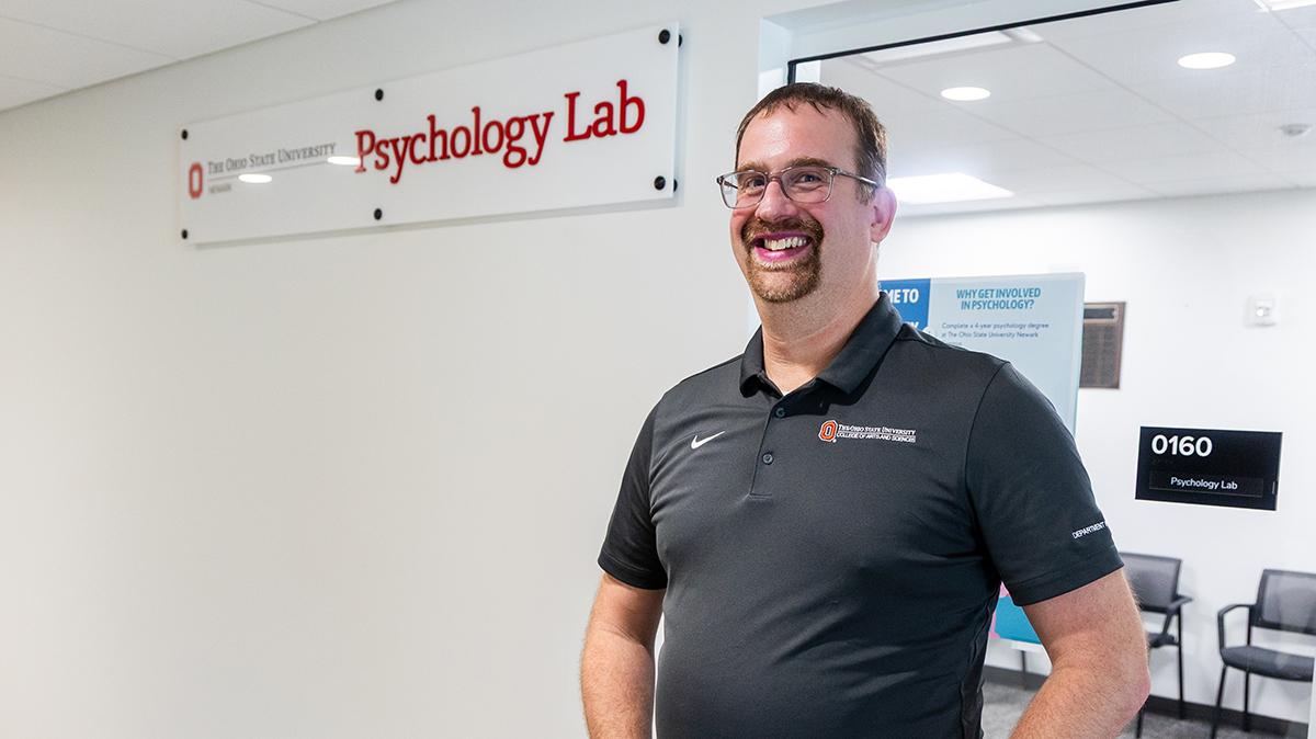 Portrait of Jim Wirth standing outside of the Psychology Lab on the Newark campus.