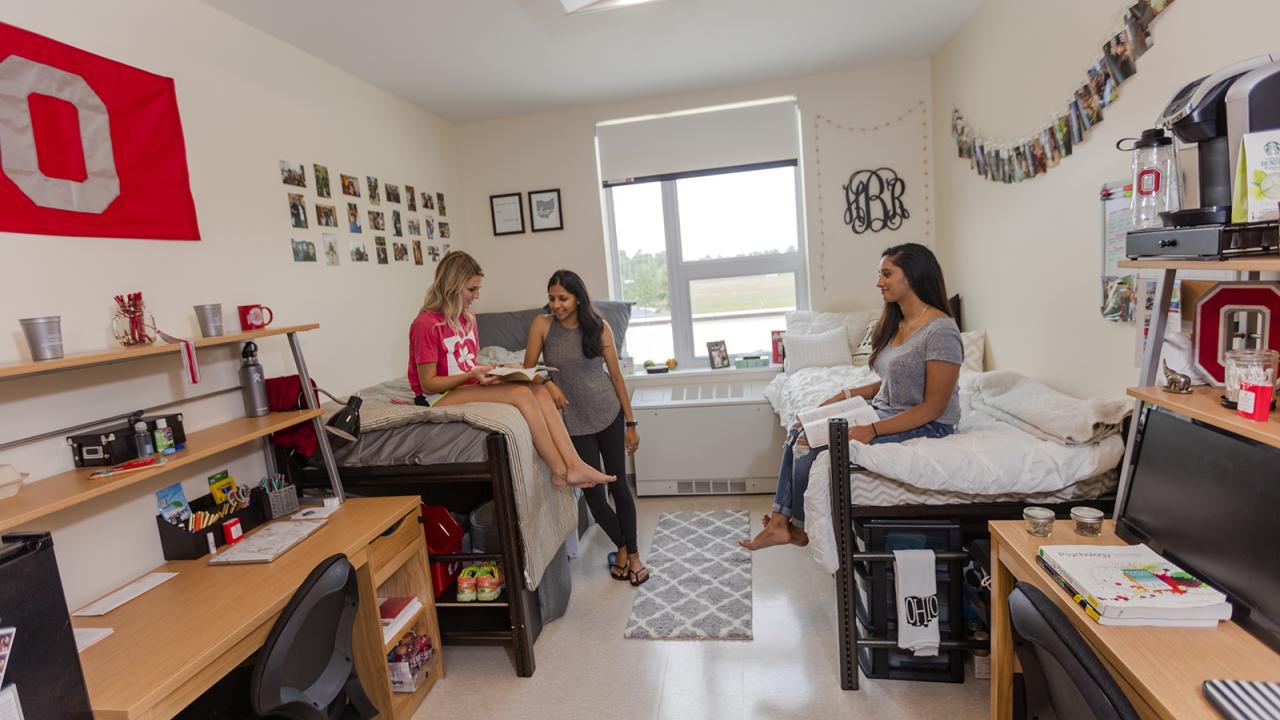Three students sit in their dorm room in McConnell Hall.