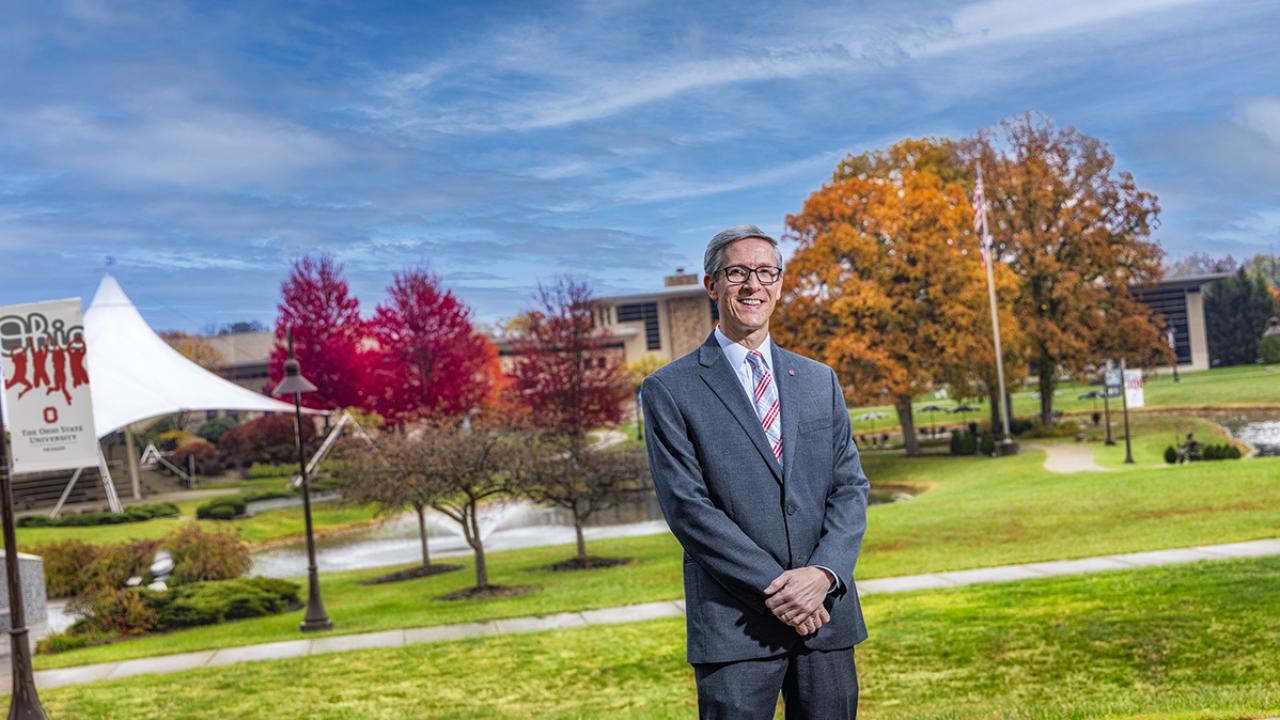 Portrait of Dean and Director Matthew Smith standing outside on the campus.