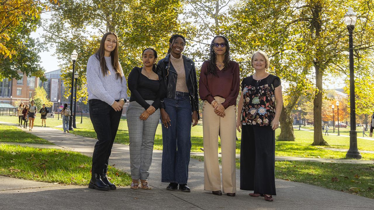 Students and faculty members stand side-by-side on the sidewalk at Ohio State's Columbus campus.