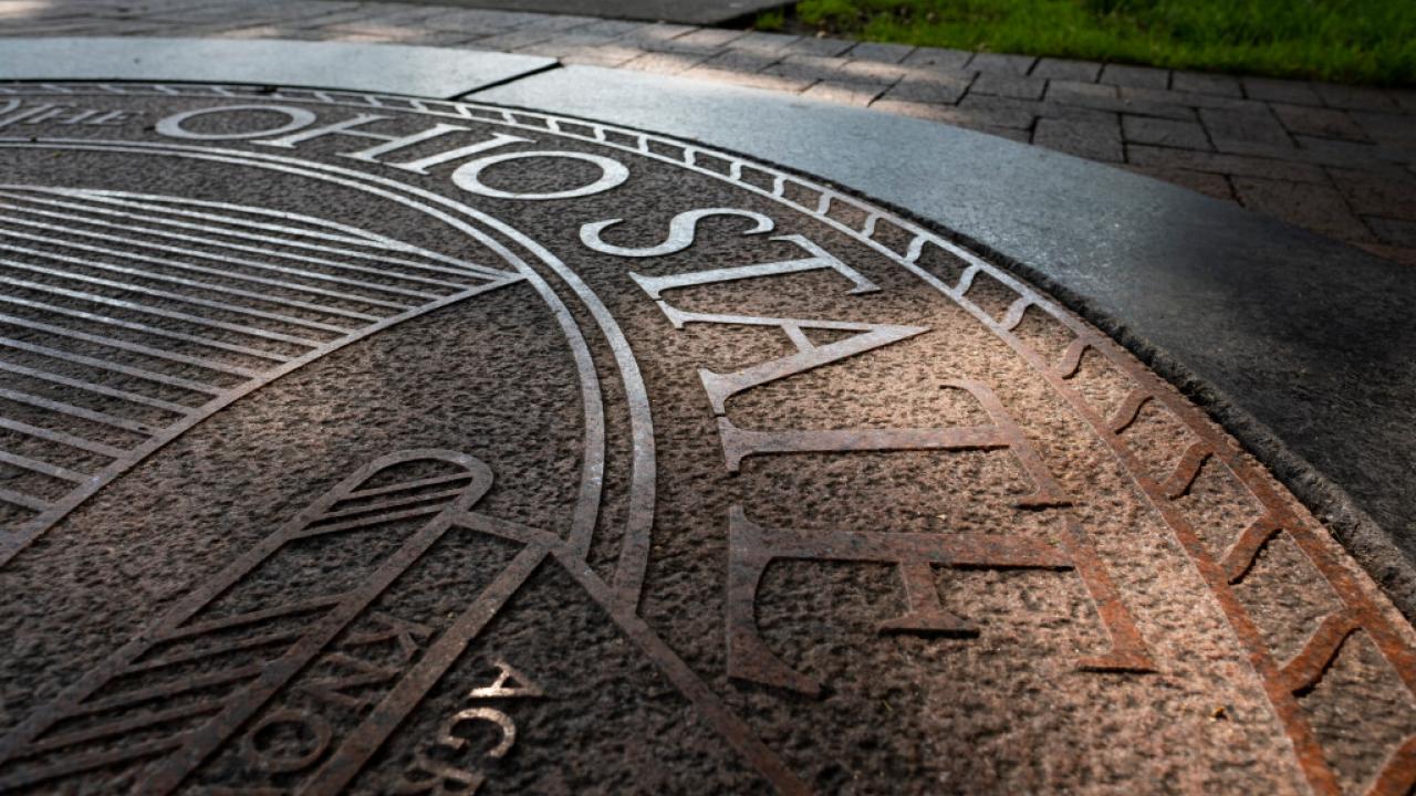 The Ohio State Seal made of stone embedded in a sidewalk. 