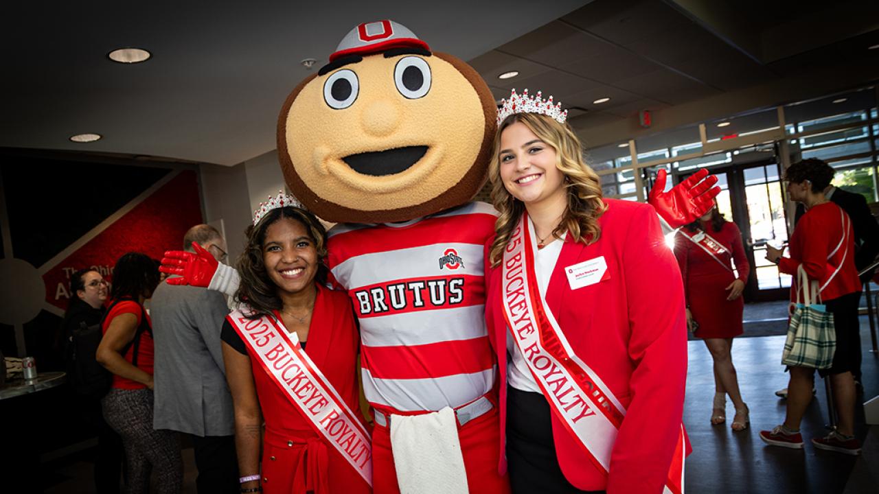 Ohio State Newark Homecoming Court members and Royal Buckeyes Nia Coats and Jaylyn Workman with Brutus Buckeye at the Longaberger Alumni House for the regional campus Homecoming recognition ceremony.