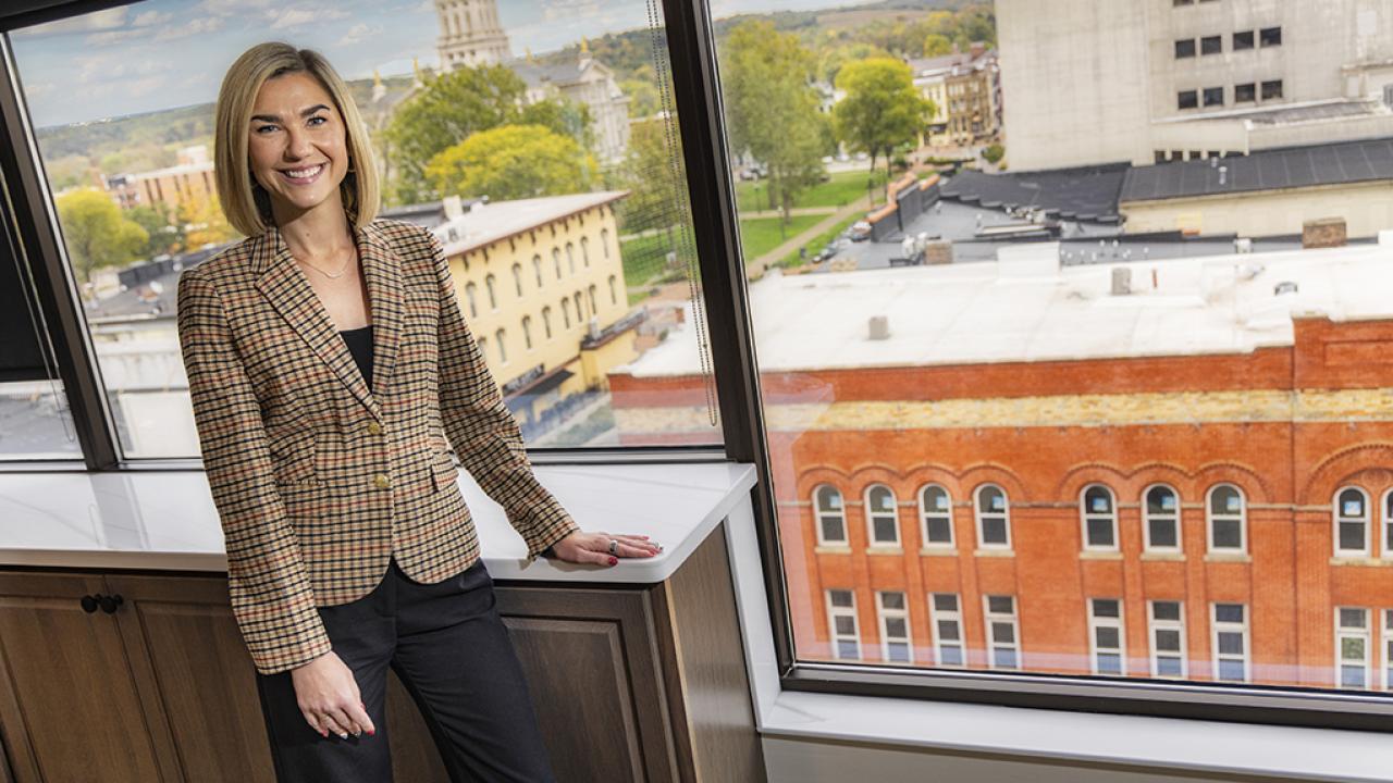 Portrait of Brittany Henry standing inside Park National Bank's downtown Newark office overlooking the courthouse and downtown square.