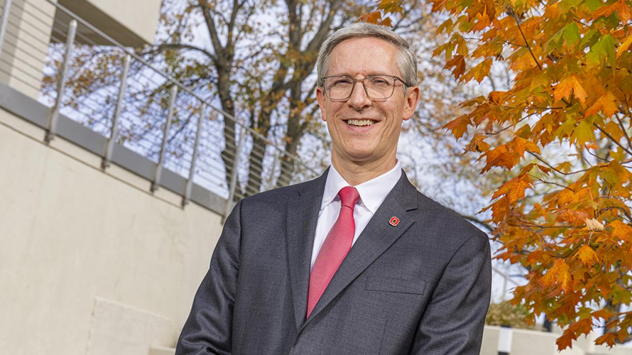 Portrait of Dean and Director Matt Smith standings outside Hodges Hall on an autumn day.